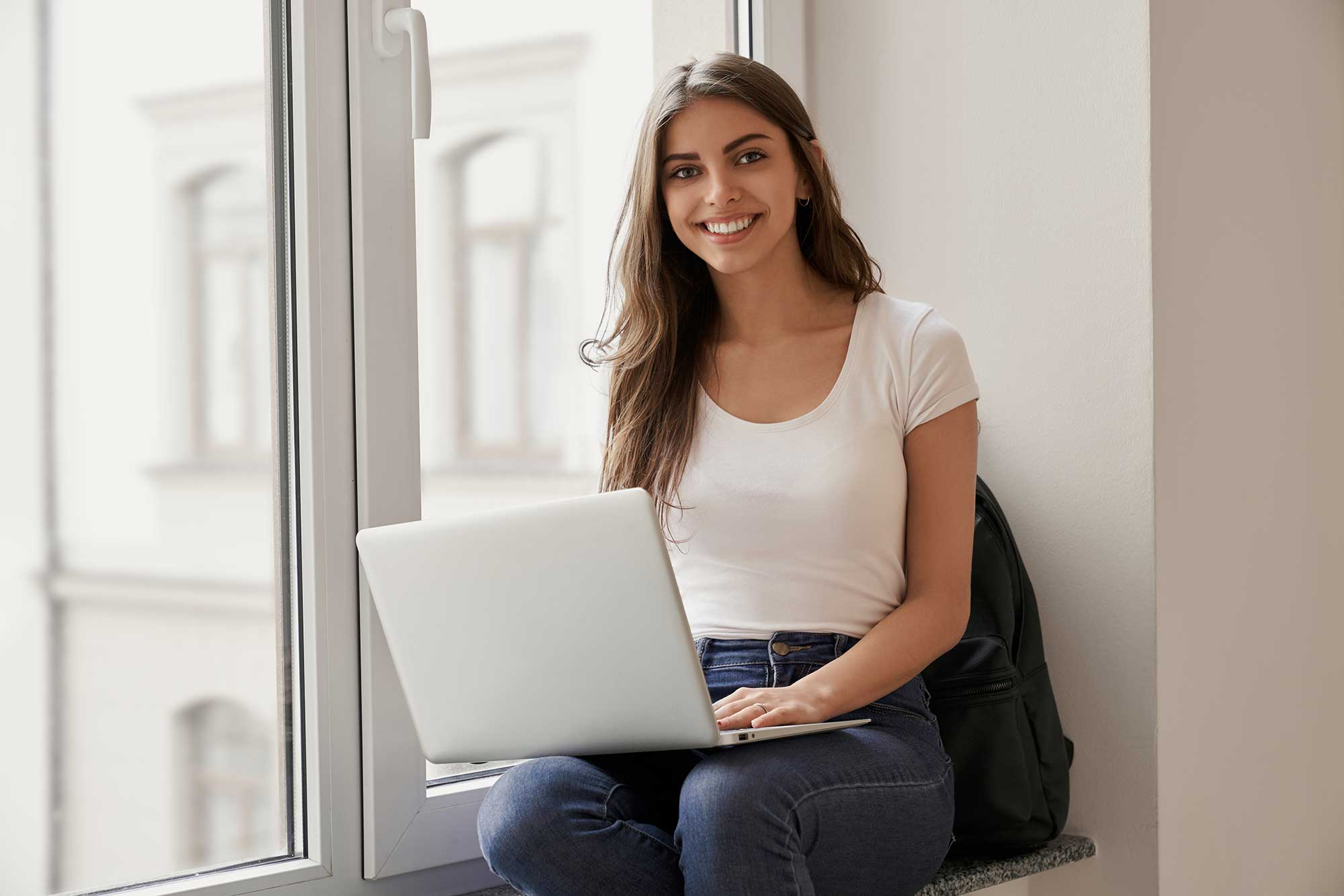 beautiful-female-student-sitting-with-laptop-on-wi-2022-01-18-23-33-22-utc.jpg